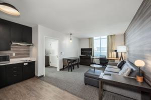 a kitchen and a living room with a couch and a table at Residence Inn Franklin Berry Farms in Franklin