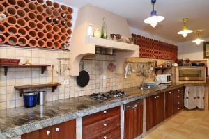 a kitchen with wooden cabinets and a counter top at Villa Nikolina in Molat