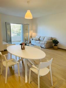 a living room with a table and chairs and a couch at Casa di Tinny in Barbusi +23 photos