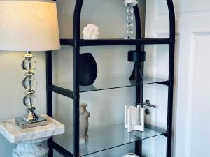 a glass shelf in a living room with a lamp at Castle Inn Apartments - Downtown Keflavík in Keflavík +26 photos