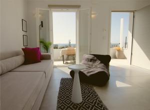 a living room with a couch and a table at AELIA Tinos in Tinos