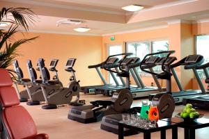 a gym with treadmills and elliptical machines at Rome Marriott Park Hotel in Rome