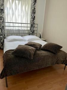 a bed with pillows on it in a bedroom at Old Town View in Cologne