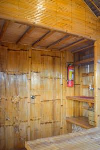 a room with a wooden wall with wooden shelves at GoOd Inn White Beach Moalboal in Cebu City
