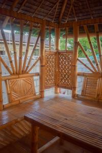 a wooden room with a wooden bench in a building at GoOd Inn White Beach Moalboal in Cebu City
