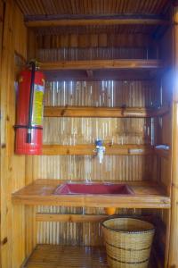 a bathroom with a fire hydrant on a wooden wall at GoOd Inn White Beach Moalboal in Cebu City +17 photos