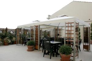 a restaurant with tables and chairs under a white canopy at Sorella Luna in Syracuse