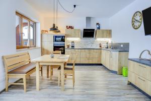 a kitchen with a wooden table and a table and chairs at Ferienwohnung Schachen in Garmisch-Partenkirchen