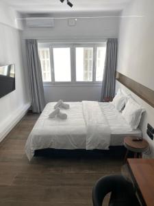 A bed or beds in a room at Athens Center Boutique Suites