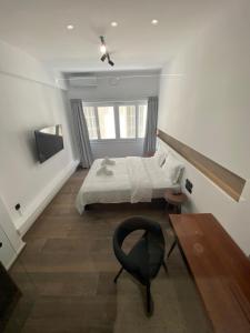 A bed or beds in a room at Athens Center Boutique Suites