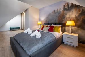 sypialnia z dużym łóżkiem z ręcznikami w obiekcie Rezydencja Strążyska w Zakopanem