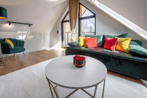 a living room with a couch and a table at Rezydencja Strążyska in Zakopane