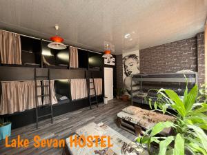 a room with bunk beds and a brick wall at Lake Sevan Hostel in Sevan