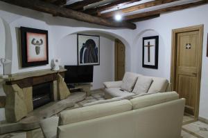 a living room with a couch and a fireplace at Residenza di Campagna Seranile in Dorgali