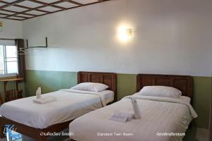 Letto o letti in una camera di Baan Khue Wieng Resort