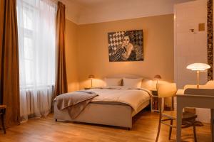 a bedroom with a bed and a painting on the wall at St.Jacobs's apartments Old Town Riga in Rīga +24 photos