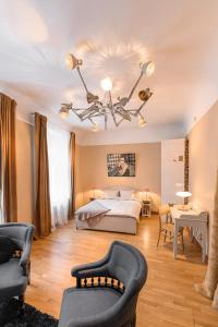 a large bedroom with a bed and two chairs at St.Jacobs's apartments Old Town Riga in Rīga