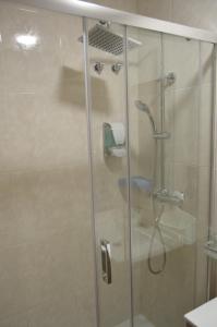 a shower with a glass door in a bathroom at Hotel Restaurante Val in Antas de Ulla +50 photos
