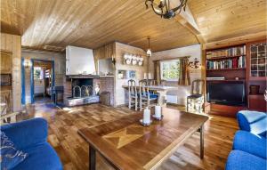 a living room with a wooden ceiling and a table at Stunning Home In Eggedal With Kitchen in Eggedal
