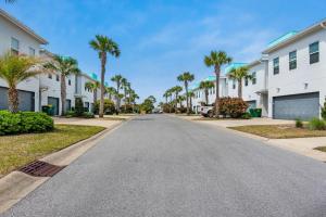 a street in a villa with palm trees at Pelican at Sound Side in Fort Walton Beach
