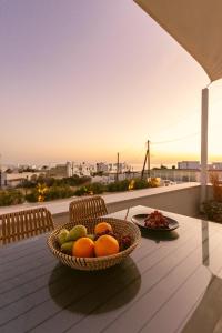 kosz owoców na stole na balkonie w obiekcie AELIA Tinos w mieście Tinos