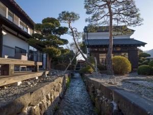 a river in front of a building with a house at MITSU-House in Nishikatsuracho