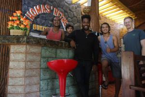 a group of people standing in front of a bar at Thomas' Retreat Bukit Lawang in Bukit Lawang