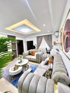 a living room with a couch and a table at Bee-City Homes in Abuja