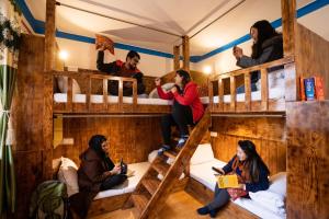 a group of people sitting in bunk beds at Rainbow Hostelier in Leh