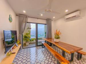 a room with a wooden table and a balcony at Happy House Homestay 2 in Hue
