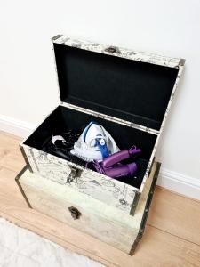 a wooden chest with a drawer with a shoe and other items in it at Canterbury romantic modern home in Goodnestone