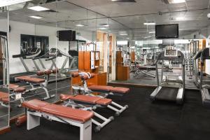 a gym with several tread machines and a tv at Sharm Dreams Vacation Club - Aqua Park in Sharm El Sheikh