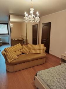 a living room with a couch and a chandelier at Pozlovice225 in Pozlovice