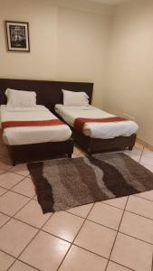 two beds sitting next to each other in a room at تالين الجامعي in Riyadh