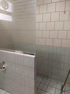 a bathroom with white tiled walls and a window at تالين الجامعي in Riyadh