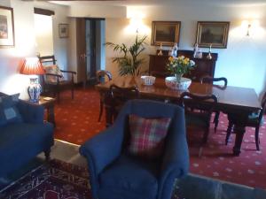 a living room with a dining room table and chairs at Buckle Yeat in Sawrey