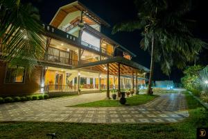 a house with a palm tree in front of it at Anura's Elephant in Beruwala