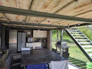 a kitchen with a table and chairs in a house at Le Floyon (avec piscine) in Florennes
