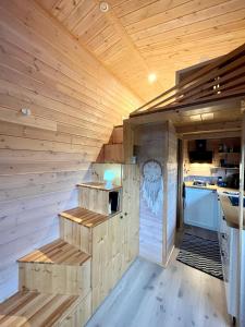 a sauna with wooden walls and stairs in a kitchen at The Grey Tiny in Chimay