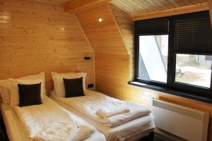 a room with two beds in a log cabin at Boro Green Holiday Village in Borovets
