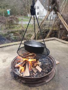 una sartén colgando sobre un fuego con una olla en ella en Fachwerk zum Entspannen, max. 3P, en Bad Emstal