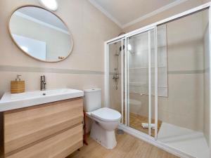 a bathroom with a toilet and a mirror at Caleta Beach House Villa Beatriz Sinese Design in Torre del Mar