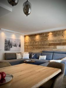 a living room with a couch and a wooden table at Spacious 3 Room Apartment - Family-Friendly - Central Leukerbad - Great Views in Leukerbad