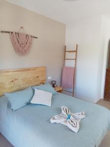a bedroom with a bed with a bow on it at Casa LIMA in Viñuela