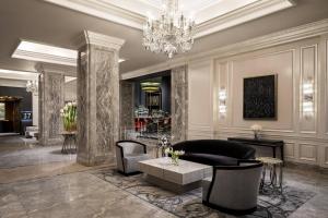a lobby with a chandelier and a couch and chairs at The Ritz-Carlton, San Francisco in San Francisco