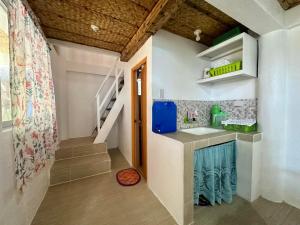 a kitchen with a sink and a counter in a room at Lorenza 2 and 3 in Buruanga