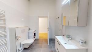 ein weißes Bad mit einem WC und einem Waschbecken in der Unterkunft ALON HOMES Vienna - Premium Apartments City Center - Contactless Self-Check-In in Wien