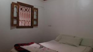 A bed or beds in a room at Gîte Assafar
