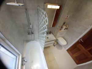 a bathroom with a tub and a toilet and a sink at Luxury holiday home, near beach in Southend-on-Sea
