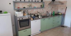 a kitchen with a sink and a stove top oven at Vallessa Vip in Vinkuran